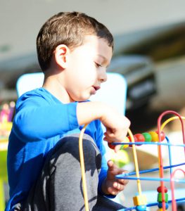 boy plays with motor toys during screening